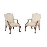 A pair of mahogany and upholstered armchairs