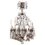 A French patinated metal and clear and tinted glass hung eight branch chandelier