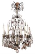 A French patinated metal and clear and tinted glass hung eight branch chandelier