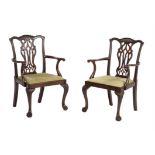 A pair of mahogany open arm chairs in George III style
