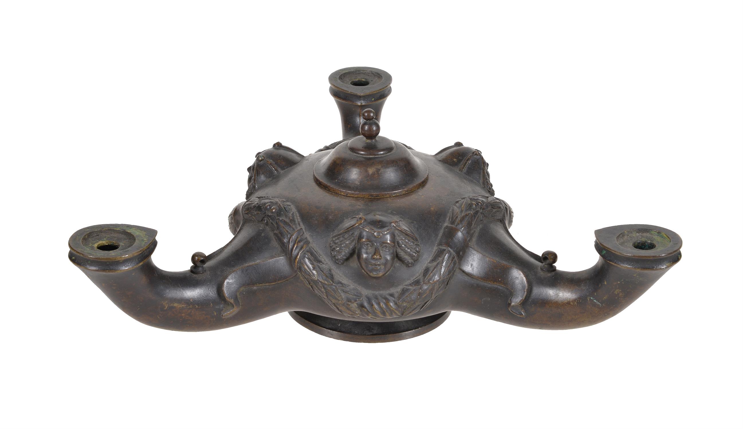 A bronze tripartite oil lamp in ancient Pompeiian style