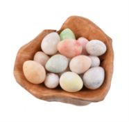 A collection of sixteen turned and coloured alabaster models of eggs