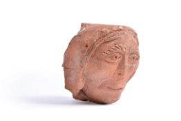 An English sculpted and carved terracotta corbel head