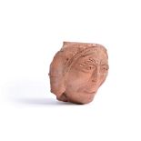 An English sculpted and carved terracotta corbel head