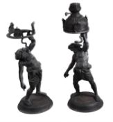 A companion pair of patinated bronze models of Silenus after the Antique