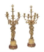 A pair of Napoleon III gilt bronze and stained wood mounted six-light figural candelabra