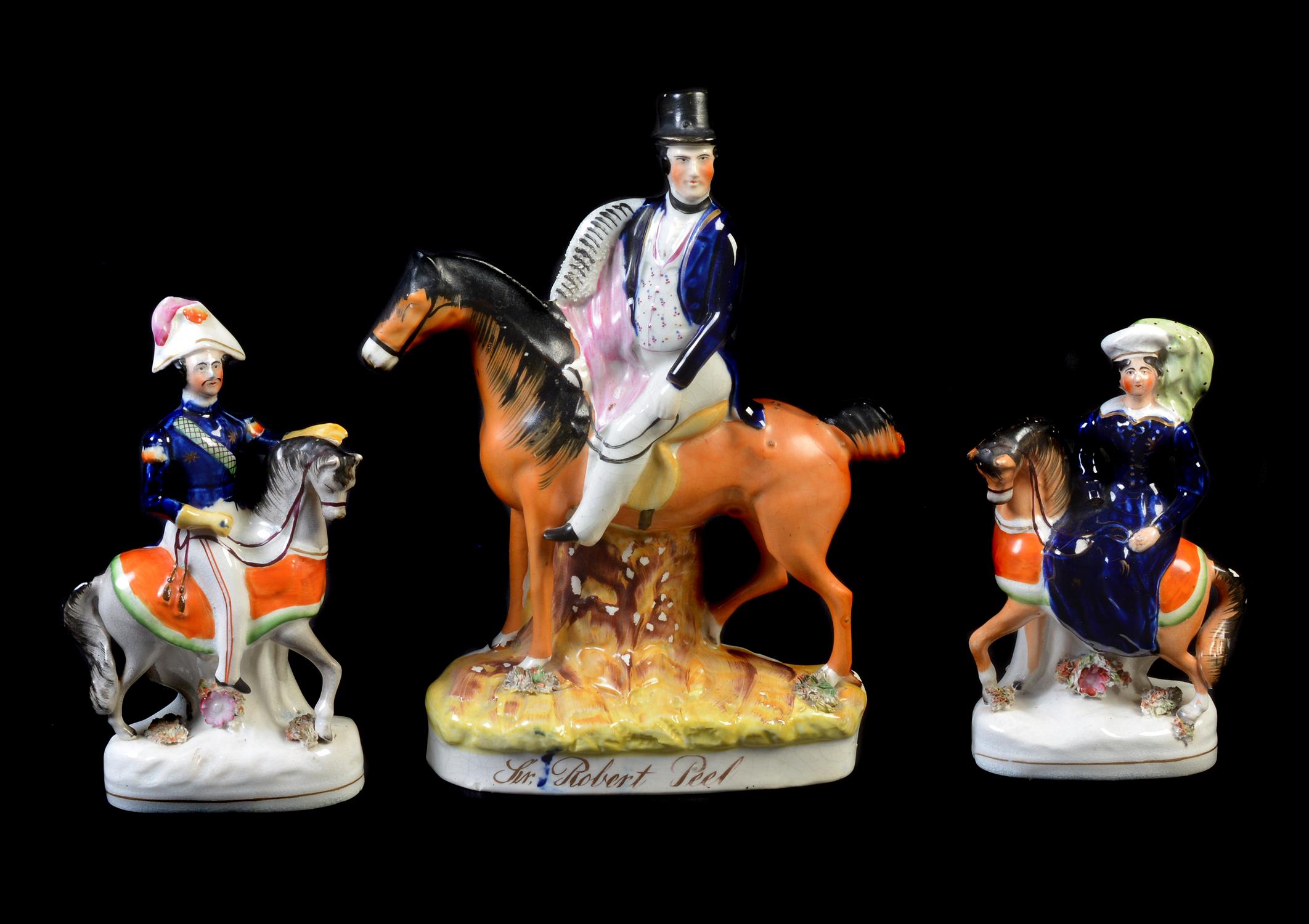 A group of three Staffordshire equestrian figures