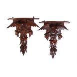 A pair of Continental carved walnut wall brackets