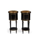 A pair of ebonised and gilt metal mounted cylindrical bedside cabinets