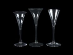 A group of three plain stemmed toasting glasses of drum trumpet form