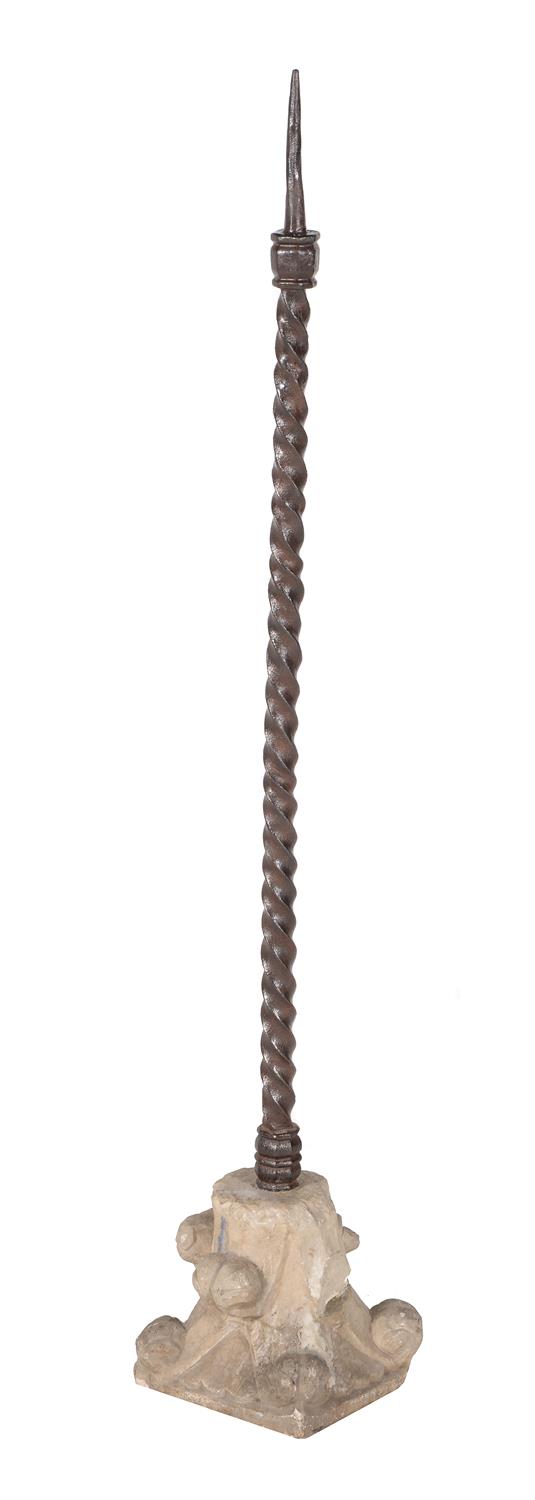 A Continental iron and limestone pricket candlestick