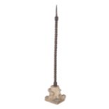 A Continental iron and limestone pricket candlestick