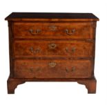 A walnut and feather banded chest of drawers