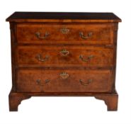 A walnut and feather banded chest of drawers