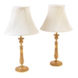 A pair of gilt metal candlestick table lamps in Charles X style