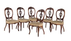 A set of six Victorian carved walnut side chairs