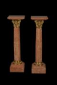 A pair of fine pink Breccia marble and gilt metal mounted columnar pedestals