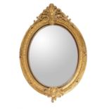 A gold painted oval wall mirror in George III revival taste