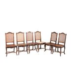 A set of six French carved beech and cane panel inset dining chairs