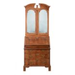 A George I walnut and featherbanded bureau bookcase