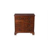 A George III mahogany and 'plum pudding' mahogany bachelor's chest of drawers