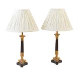 A pair of French gilt and patinated metal candlestick table lamps in Louis Philippe taste