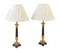 A pair of French gilt and patinated metal candlestick table lamps in Louis Philippe taste