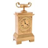 A French gilt metal mantel clock in Empire style