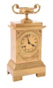 A French gilt metal mantel clock in Empire style