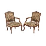 A pair of Louis XV walnut and beechwood armchairs