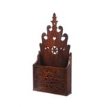 A George III carved fruitwood spoon rack or candle box