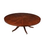 A mahogany circular extending dining table