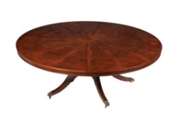A mahogany circular extending dining table
