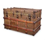 A CANVAS, WOOD AND METAL BOUND TRAVELLING TRUNK