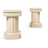 A PAIR OF WHITE PAINTED PEDESTAL BEDSIDE CABINETS