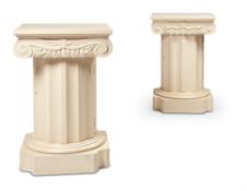 A PAIR OF WHITE PAINTED PEDESTAL BEDSIDE CABINETS