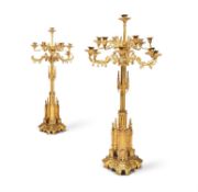 A PAIR OF IMPRESSIVE GILT BRASS GOTHIC REVIVAL CANDELABRA