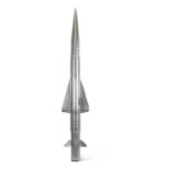 A CHROME COLOURED PLASTIC MODEL OF A MISSILE