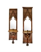 A PAIR OF GOTHIC REVIVAL CARVED OAK MIRRORED CONSOLE TABLES