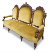 A CARVED WALNUT AND UPHOLSTERED SOFA, LATE 19TH CENTURY
