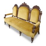 A CARVED WALNUT AND UPHOLSTERED SOFA, LATE 19TH CENTURY