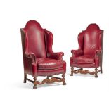 A PAIR OF VICTORIAN WALNUT AND RED LEATHER UPHOLSTERED WING ARMCHAIRS