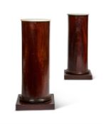 A PAIR OF MAHOGANY VENEERED AND WHITE MARBLE TOPPED COLUMNAR PEDESTALS