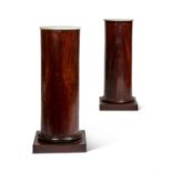 A PAIR OF MAHOGANY VENEERED AND WHITE MARBLE TOPPED COLUMNAR PEDESTALS
