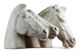 A LARGE PLASTER CAST OF THREE HORSES' HEADS