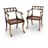 A PAIR OF REGENCY FAUX ROSEWOOD AND PARCEL GILT ARMCHAIRS