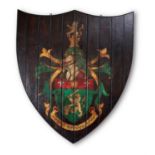 A STAINED PINE PAINTED ARMORIAL PANEL, OF CARTOUCHE SHAPE