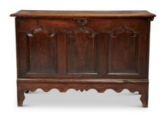 A GEORGE II CARVED OAK THREE PANEL CHEST, CIRCA 1750