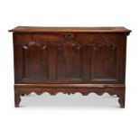 A GEORGE II CARVED OAK THREE PANEL CHEST, CIRCA 1750