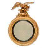 A GILTWOOD AND COMPOSITION CIRCULAR WALL MIRROR